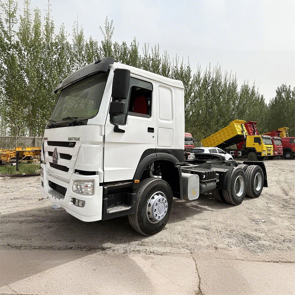 White HOWO 371HP 6×4 tractor truck front-side view in logistics yard