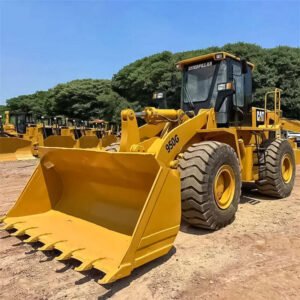 Used CAT 950 Wheel Loader lifting materials at construction site