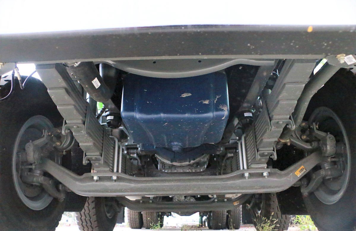 Dump truck with reinforced chassis and advanced suspension system for better stability