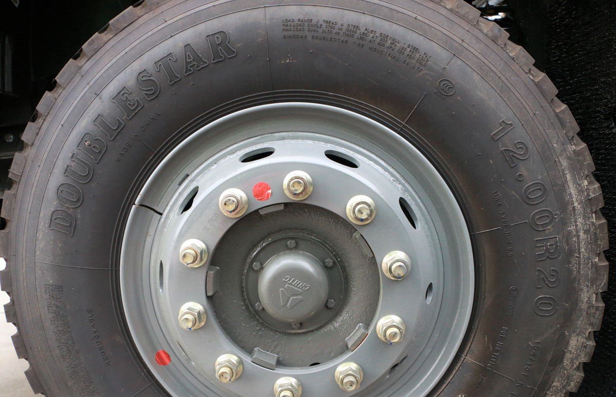 Heavy-duty dump truck equipped with rugged 12.00R20 tires for off-road use