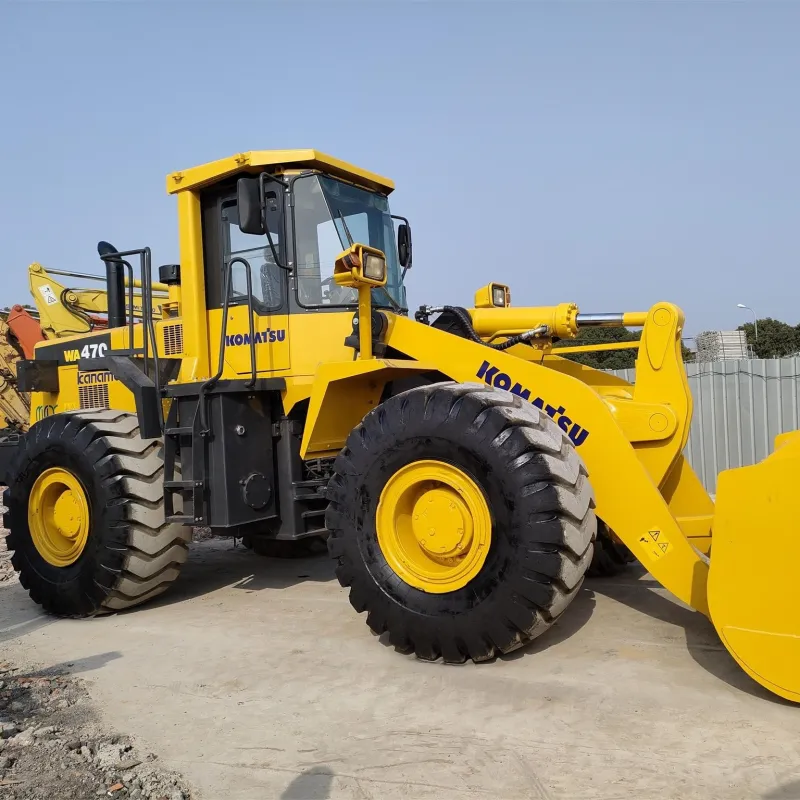 Used Komatsu WA470 wheel loader side view with bucket and tires visible
