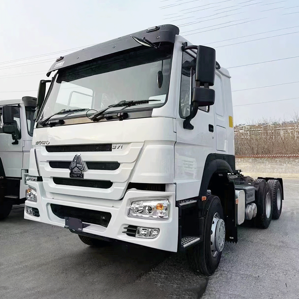 White HOWO 371HP 6×4 tractor truck front-side view in logistics yard