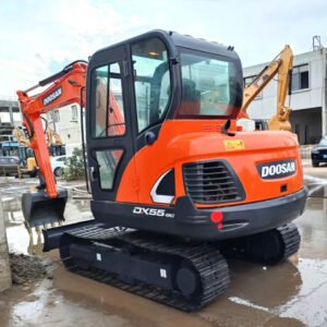 Used Doosan DX55 compact excavator with boom and bucket fully extended on construction site