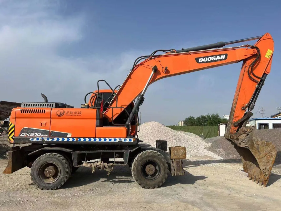 Side view of Doosan DX210W excavator with boom fully extended on site