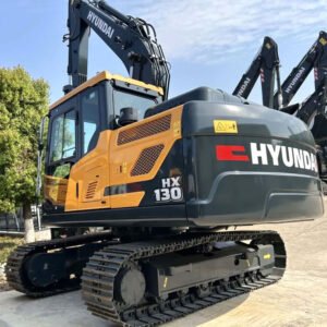 Used Hyundai 130 compact excavator with bucket lowered on site