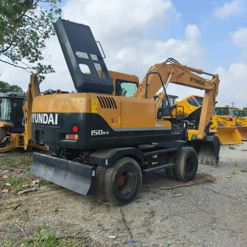Used Hyundai 150W wheeled excavator viewed from a front-side angle with boom and bucket fully extended