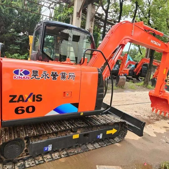 Used Hitachi EX60 ZX60 Excavator 3/4 angle view with boom extended showing hydraulic system and compact structure