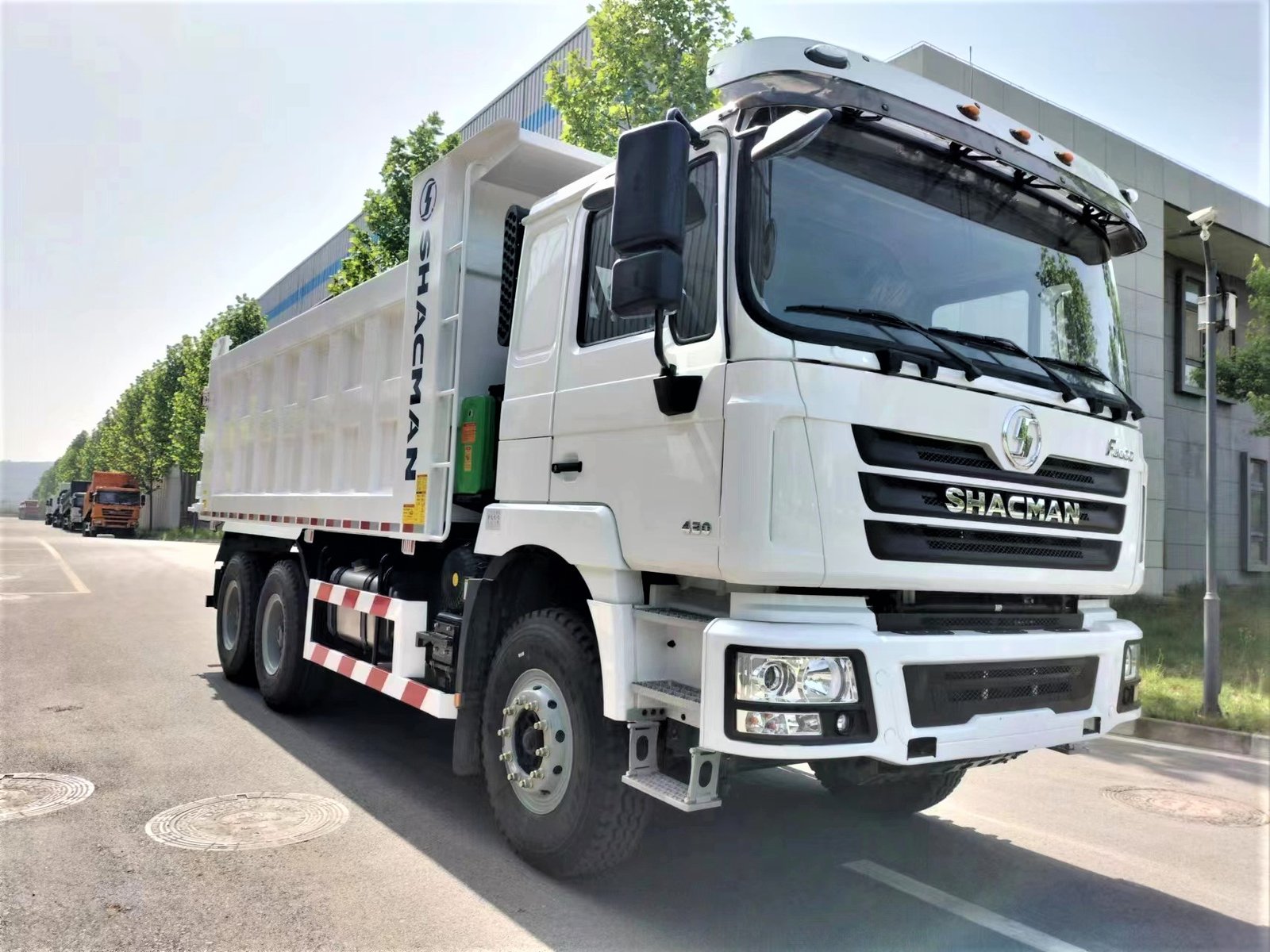 Front 3/4 view of Shacman F3000 430HP 6×4 Dump Truck showing hydraulic tipping system, robust chassis, and reinforced cargo body