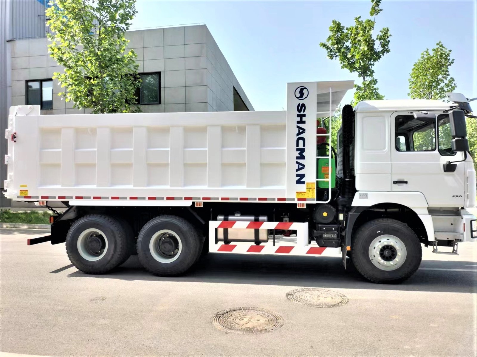 Side view of Shacman F3000 375HP 6×4 Dump Truck showing chassis, cargo body, and axles