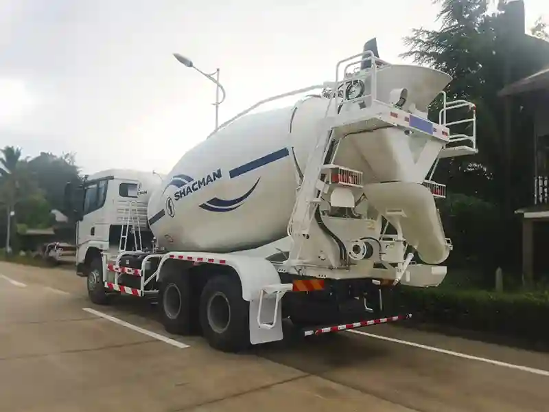 Rear view of Shacman X3000 6x4 concrete mixer truck showing mixing drum discharge chute and heavy-duty frame