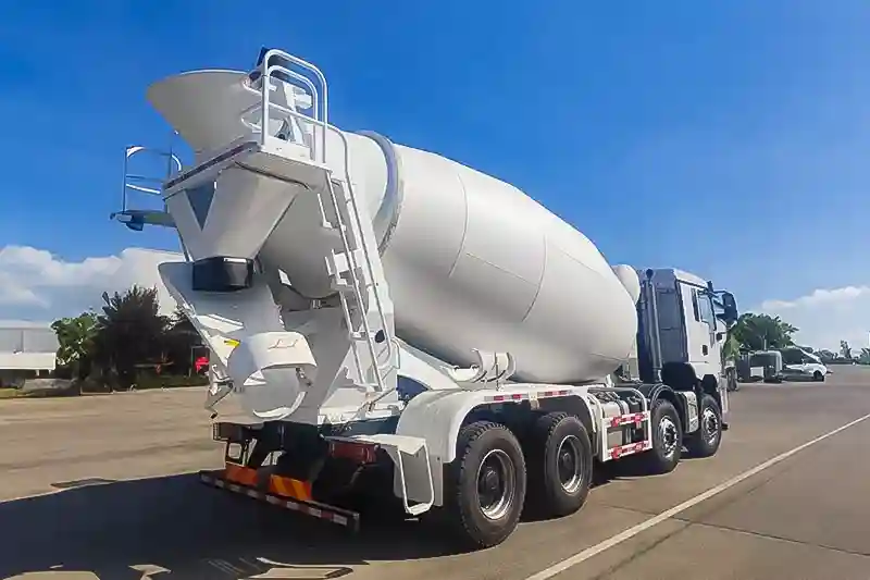 Three-quarter angle view of Shacman X3000 8x4 concrete mixer truck showing front cabin, mixing drum, and robust 8x4 chassis