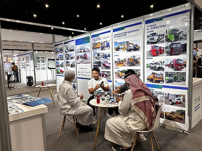 ZW sales staff showing construction machinery and trucks video to a client on a mobile device