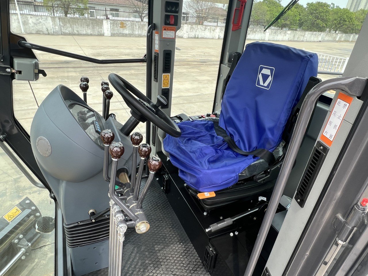 XCMG GR2153 motor grader cabin close-up showing operator seat, control panel, and interior design