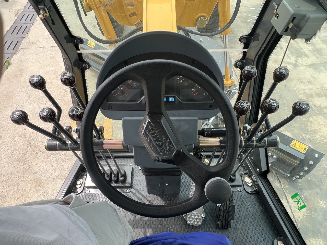 XCMG GR2153 motor grader steering wheel close-up showing operator control and cabin detail