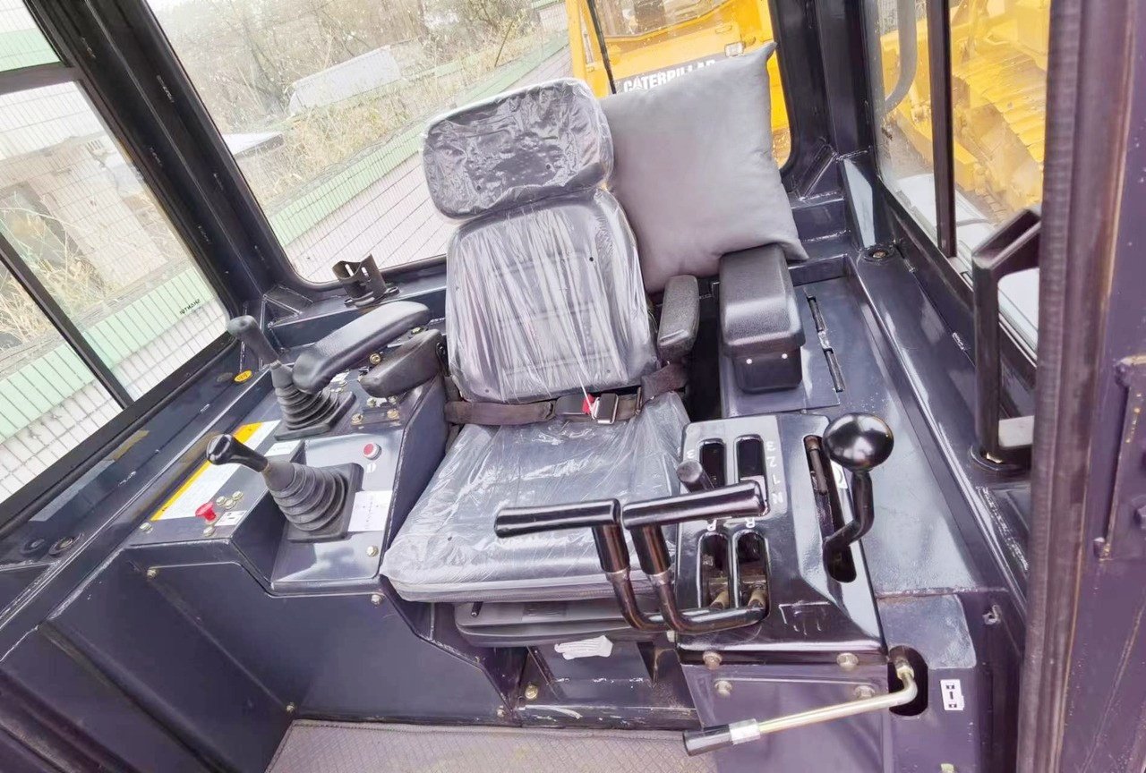 Shantui SD22 bulldozer cab interior showing operator seat, control levers, dashboard, and ergonomic cabin design for comfortable operation