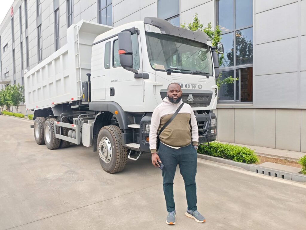 Rwandan client finalizing HOWO TX Dump Truck procurement at ZW Group facility after technical inspection.