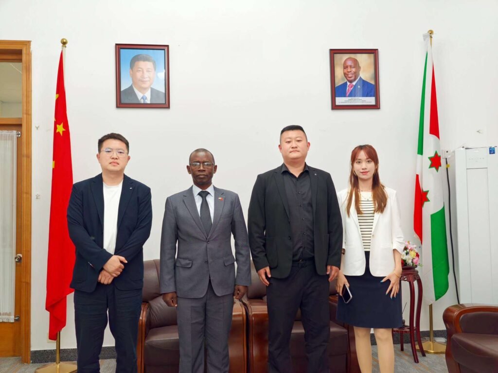 ZW Group leadership (Ivan Sun, Pierce Guo, Vera Jiang) and Burundi Ambassador H.E. Telesphore Irambona pose for a group photo at the embassy in Beijing, discussing heavy truck and machinery cooperation.