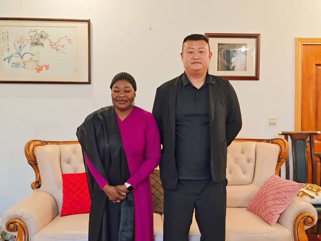 ZW Group General Manager Pierce Guo (Guo Zhike) and Guinea Ambassador H.E. Aminata Koita, focusing on engineering equipment logistics and service responsiveness for West Africa.