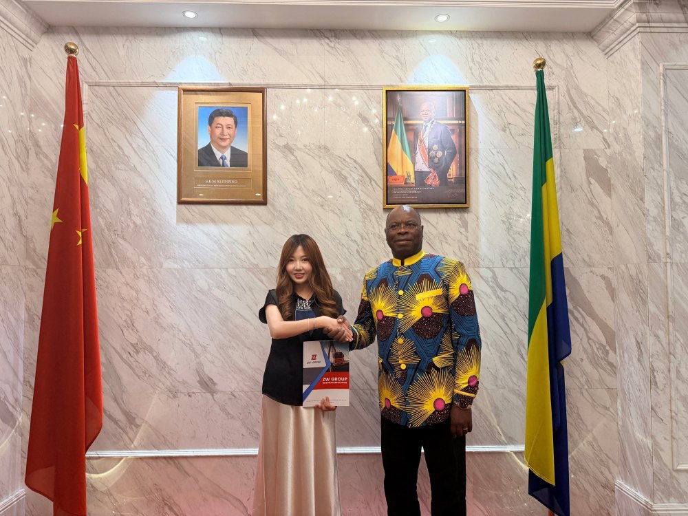 Gabon Ambassador presenting the product brochure with ZW Group, an expert Commercial Vehicle Manufacturer China.