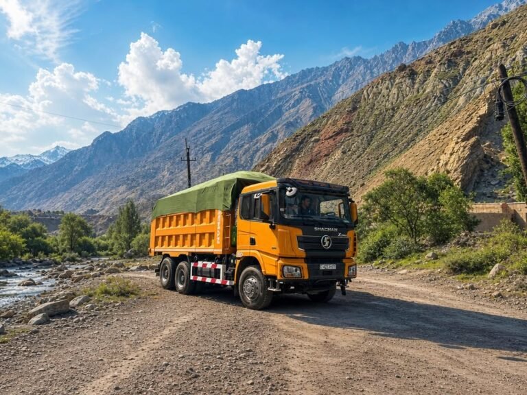 Yellow Shacman 6x4 dump truck operating on rugged mountain road for heavy payload evaluation