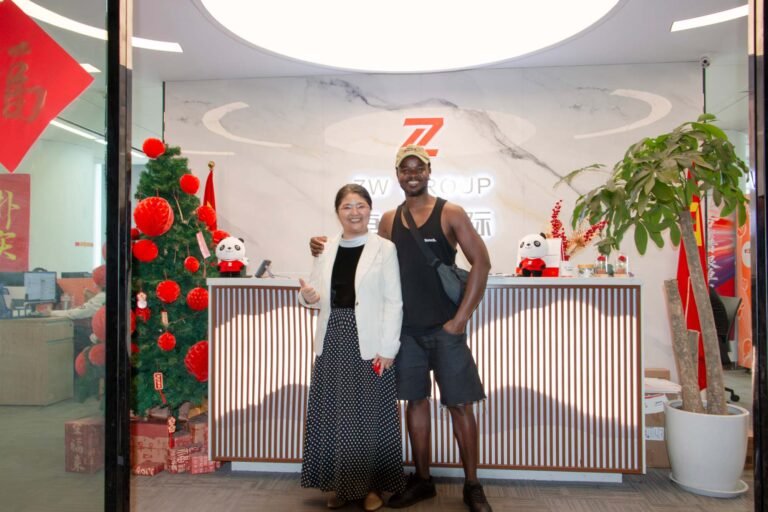 African client visiting ZW Group office headquarters to discuss HOWO dump truck procurement.